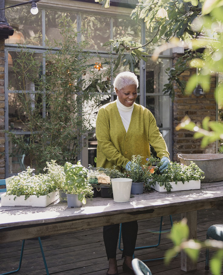 elderly woman potting plants
