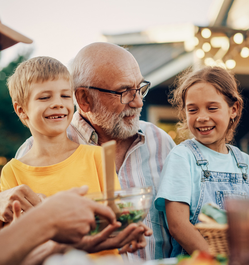 Grandfather with two grandchildren in his lap