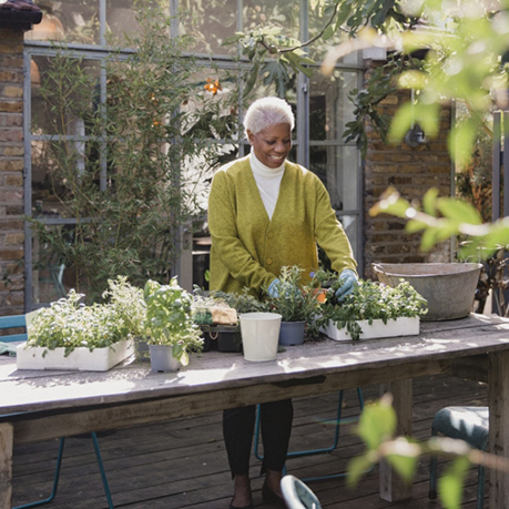 elderly woman potting plants