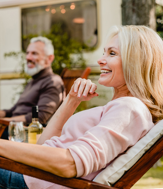 woman leaning back into patio chair